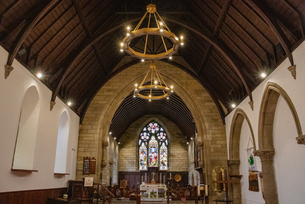 Gold Herschel Halo infrared heaters suspended beneath the vaulted timber roof at St Peter’s Church, Galashiels